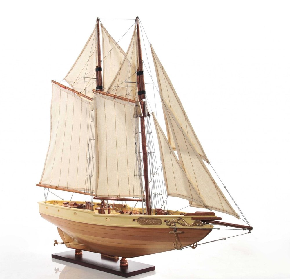 24" Brown Solid Wood Hand Painted Model Boat. Home product isolated on a plain white background, showing a brown wood surface.