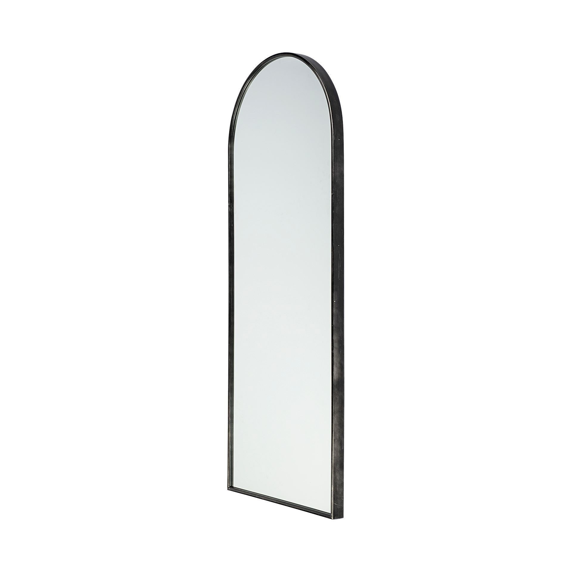 Black metal arched framed full length mirror on a white background.