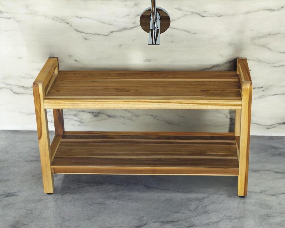 35" Natural Teak Rectangular Shower Bench With Shelf styled in a furnished interior with an off-white wall on a tiled floor.