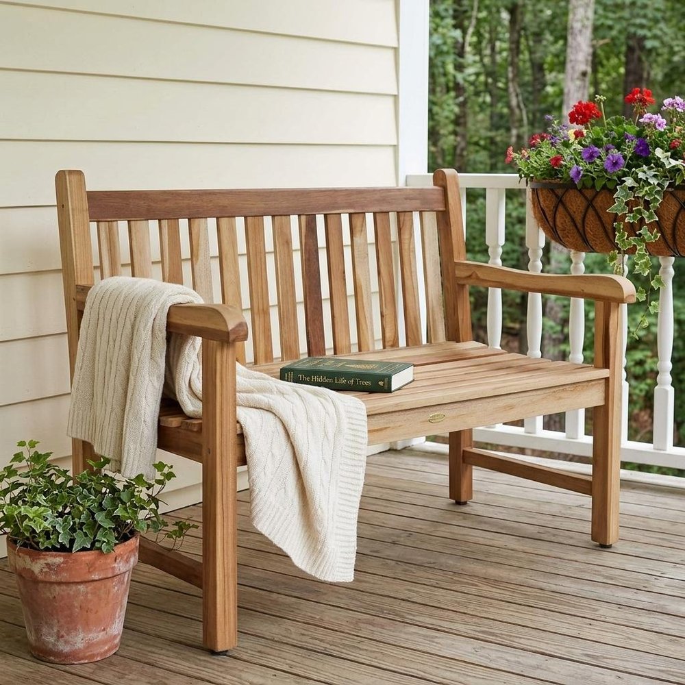 26" Natural Teak Solid Wood Garden Bench shown outdoors on a patio with greenery in tan wood.