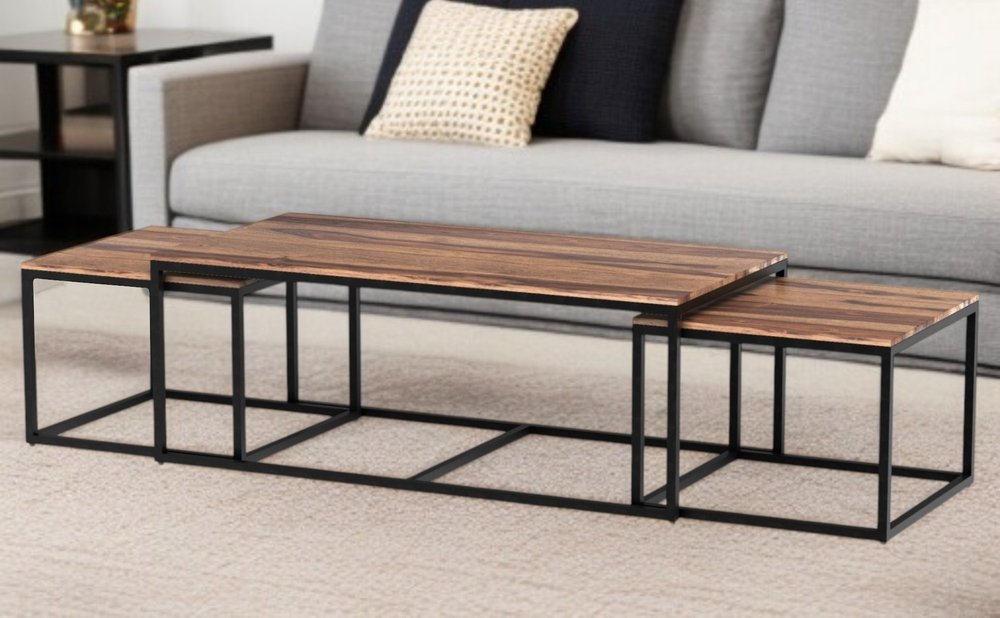 Set of Three 47" Natural And Black Solid Wood And Iron Coffee Table in a home interior