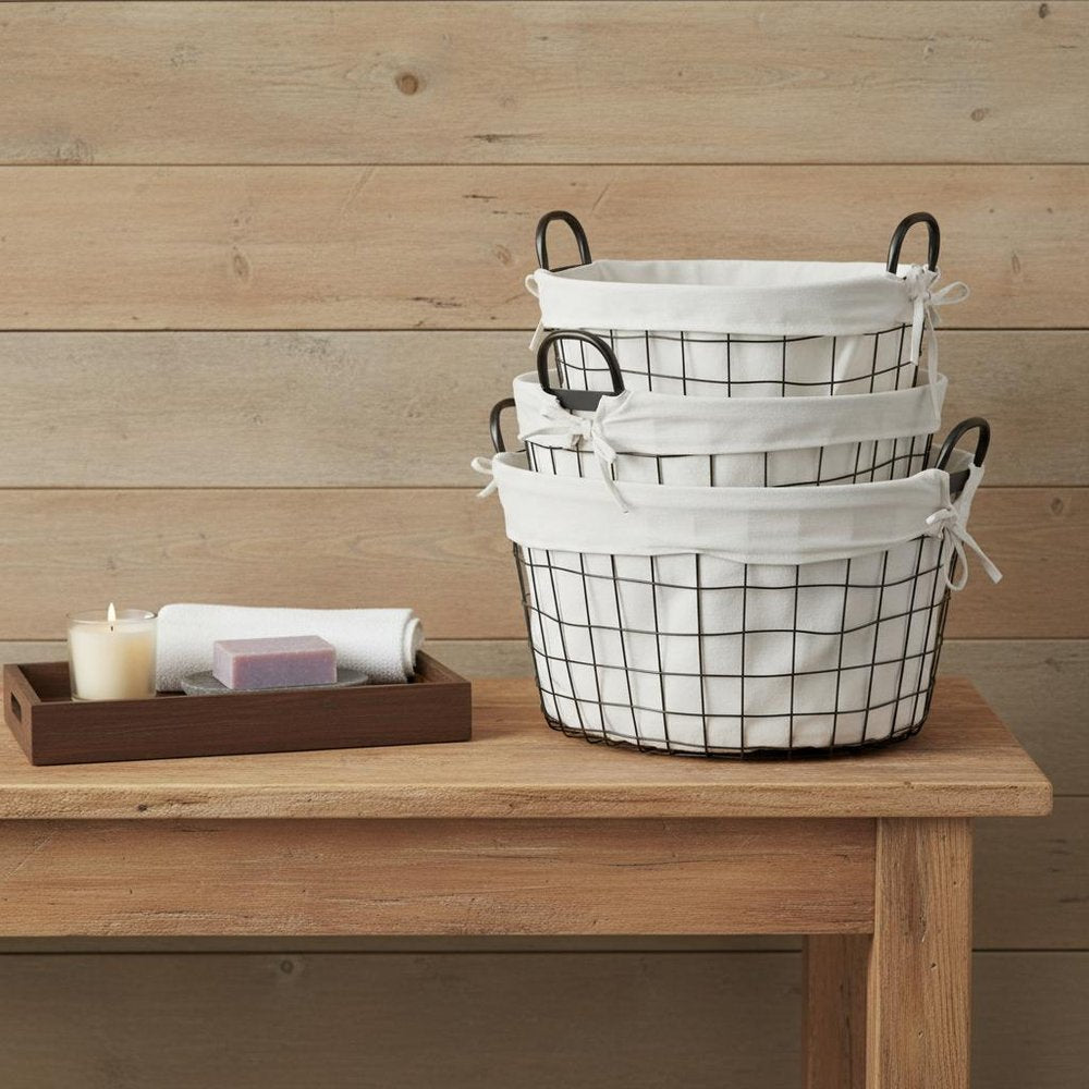 Set Of Three Black Oval Wire Baskets with White Fabric Liners and Handles in a home interior