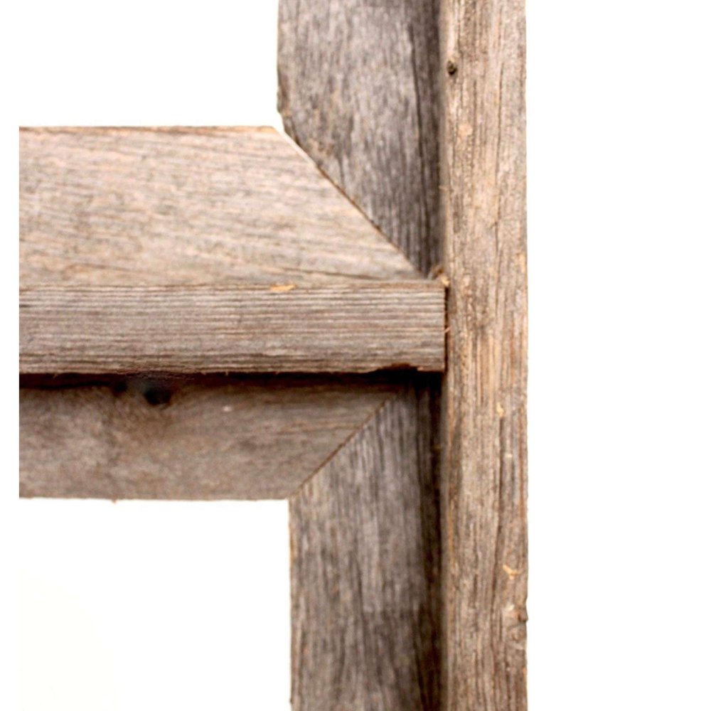 Close-up of a weathered gray solid wood picture frame corner, showing joinery and wood grain against a white background.