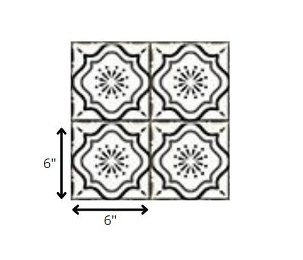 Four 6" x 6" black and white mosaic peel and stick tiles with a floral pattern on a white background.
