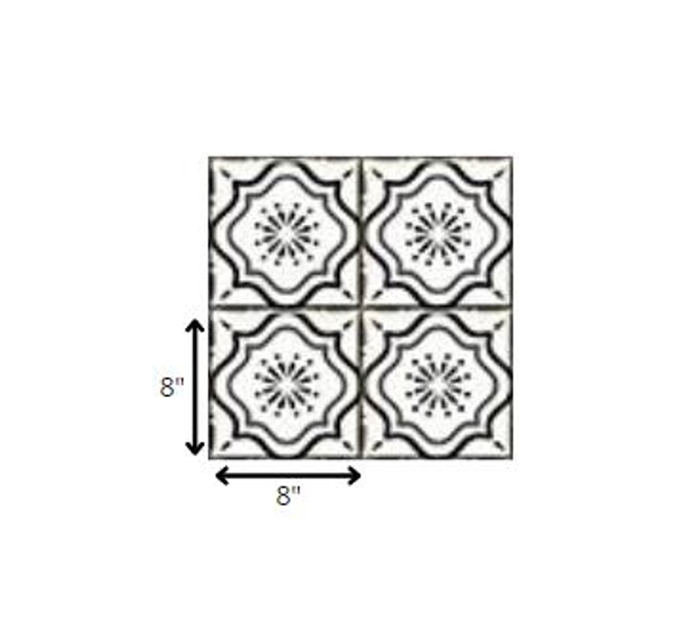 Four 8" x 8" black and white mosaic peel and stick tiles with a floral pattern on a white background.
