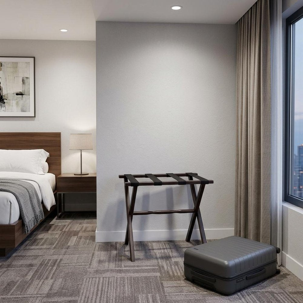 Hotel Dark Walnut Finish Wood Folding Luggage Rack With Black Straps in a home interior