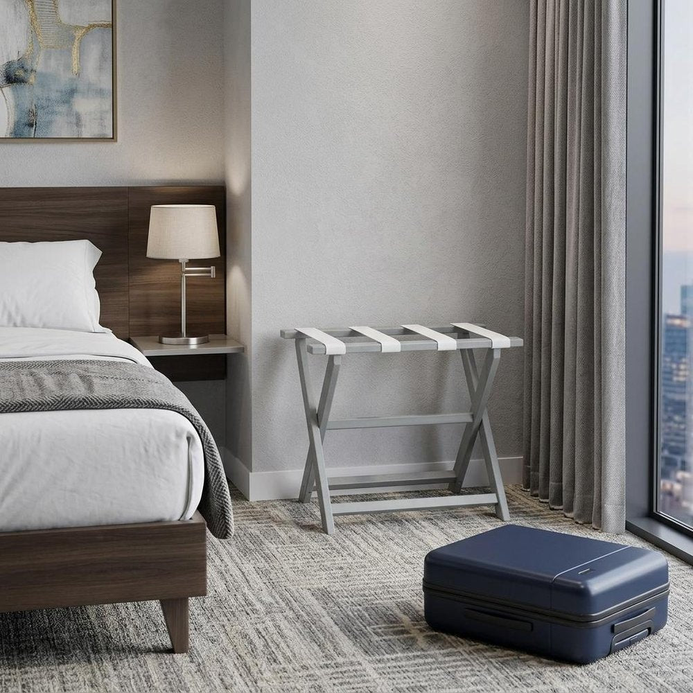 Earth Friendly Light Gray Folding Luggage Rack With White Straps in a home interior