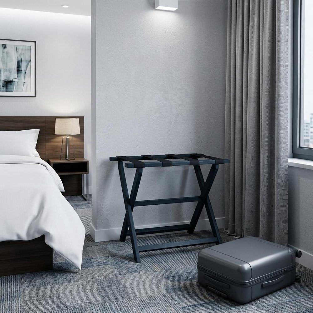 Earth Friendly Navy Blue Folding Luggage Rack With Navy Straps in a home interior