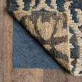 6' x 9' Gray Non Slip Rug Pad shown as a full-frame view of the tan and mahogany surface.