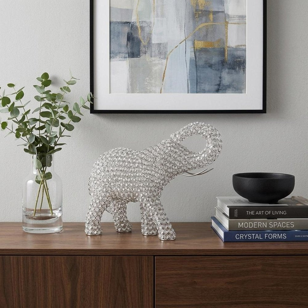 15" Silver Faux Crystal and Silver Tabletop Sculpture styled in a furnished interior with an off-white wall on a dark wood floor.