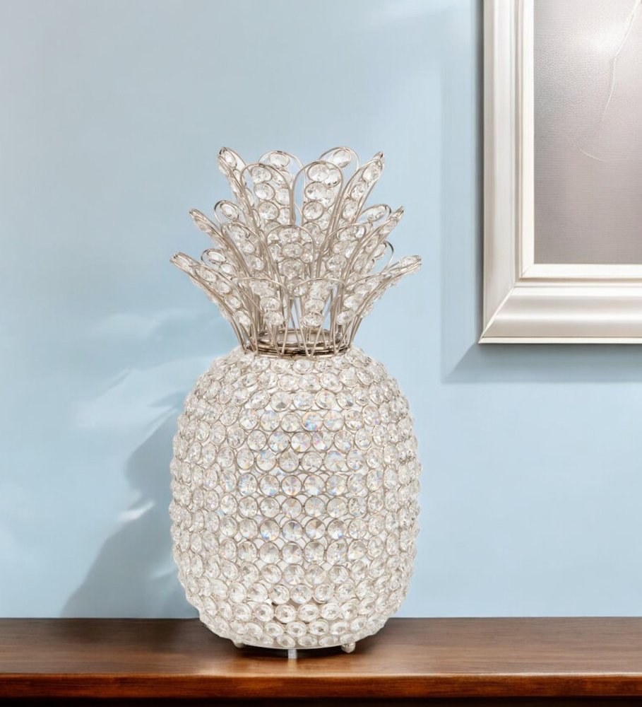 15" Silver Faux Crystal Decorative Pineapple shown outdoors on an outdoor setting.