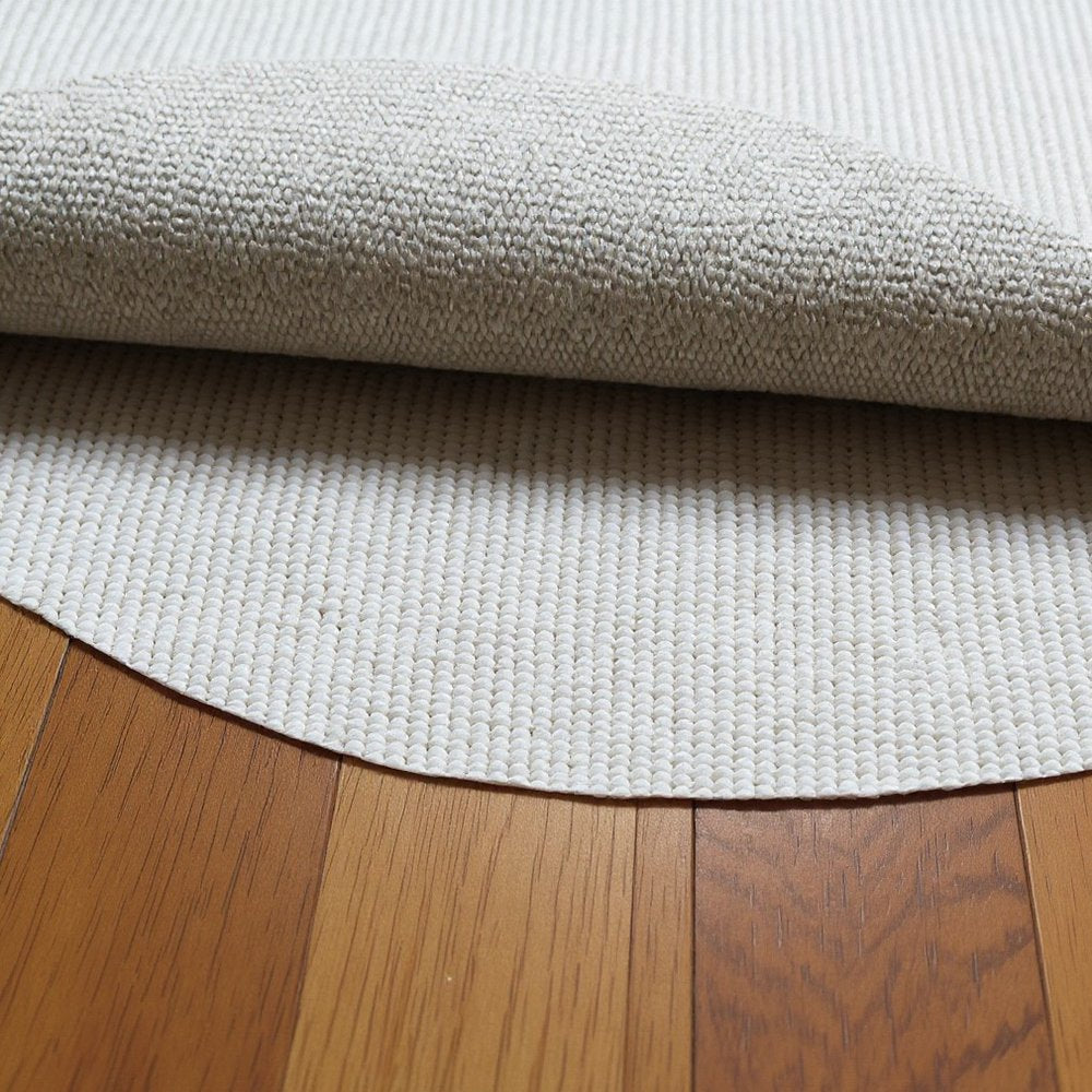8' Round Beige Non Slip Rug Pad in a home interior