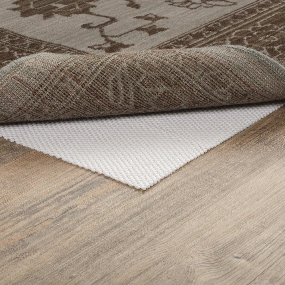 8' Round Beige Non Slip Rug Pad in a home interior