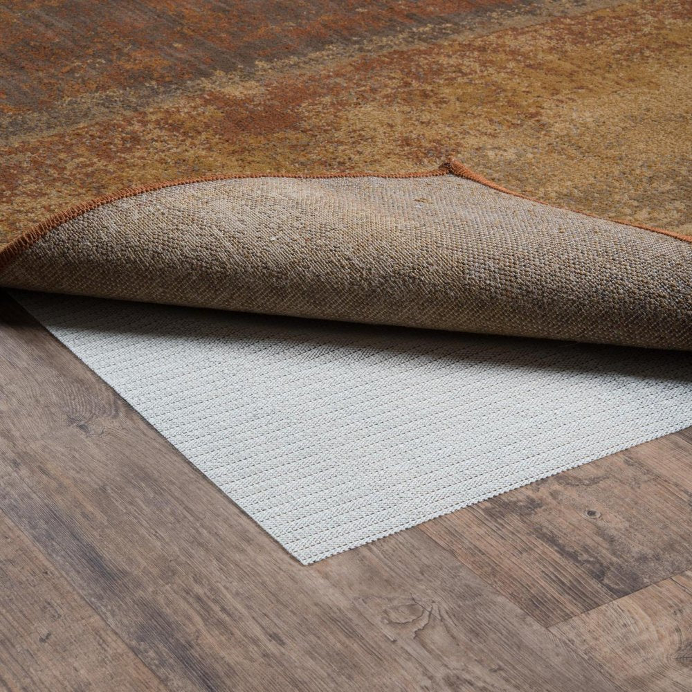 8' X 11' Beige Non Slip Rug Pad shown as a full-frame view of the dark brown and tan surface.