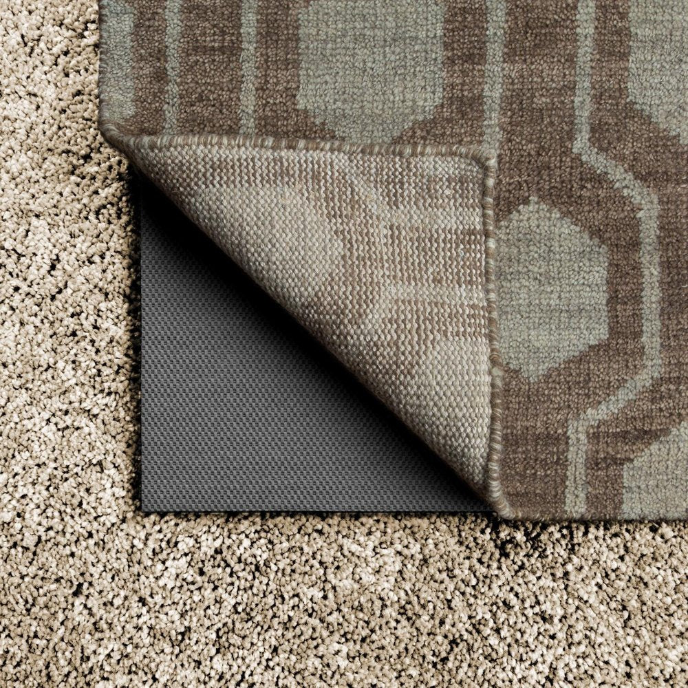 6' x 9' Gray Non Slip Rug Pad shown as a full-frame view of the tan and dark brown surface.