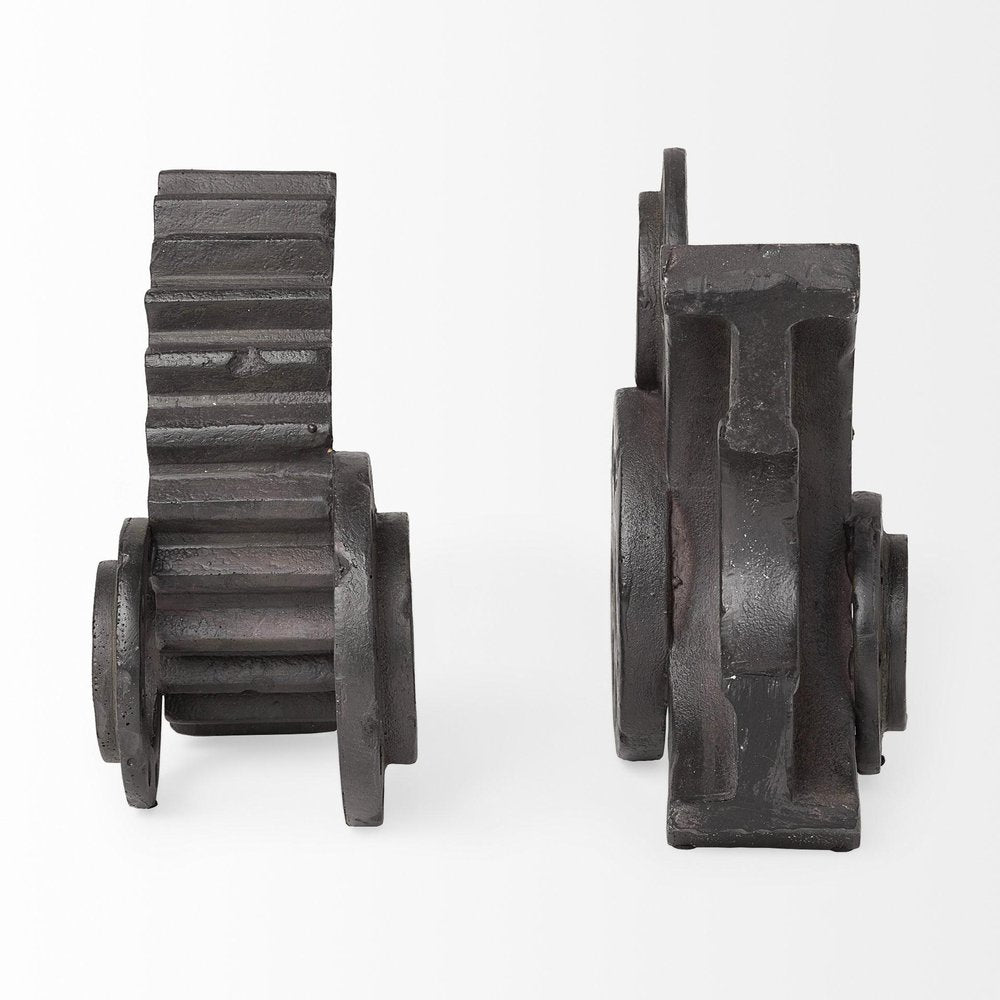 Two matte black industrial cog bookends on a white background.