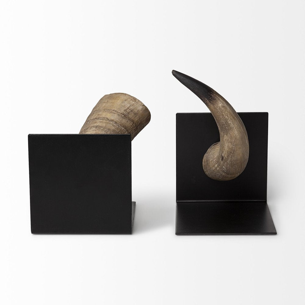 Two black metal bookends holding brown and black resin horns against a white background.