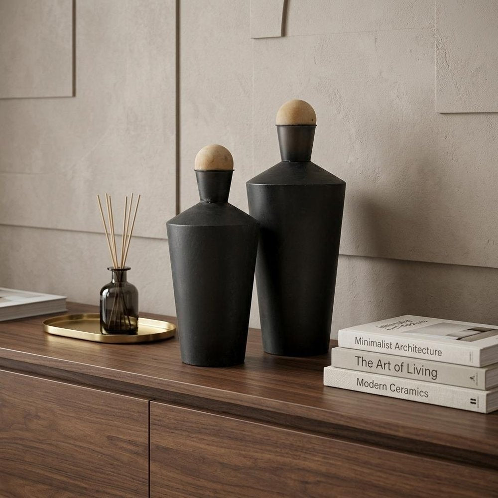 Set of Two Black and Brown Metal Cylindrical Urns in a home interior