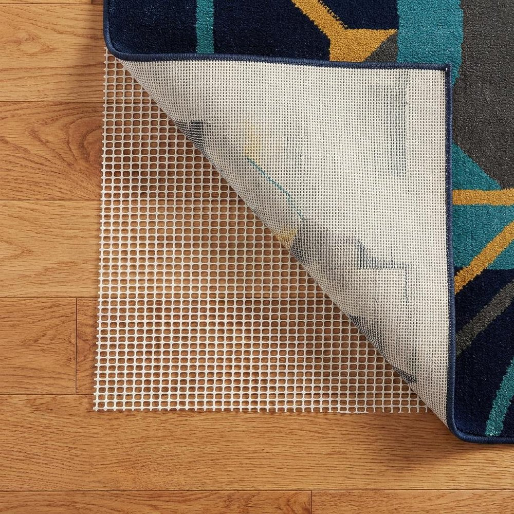 6' x 9' Ivory Striped Weave Non Slip Rug Pad shown as a full-frame view of the tan and mahogany surface.