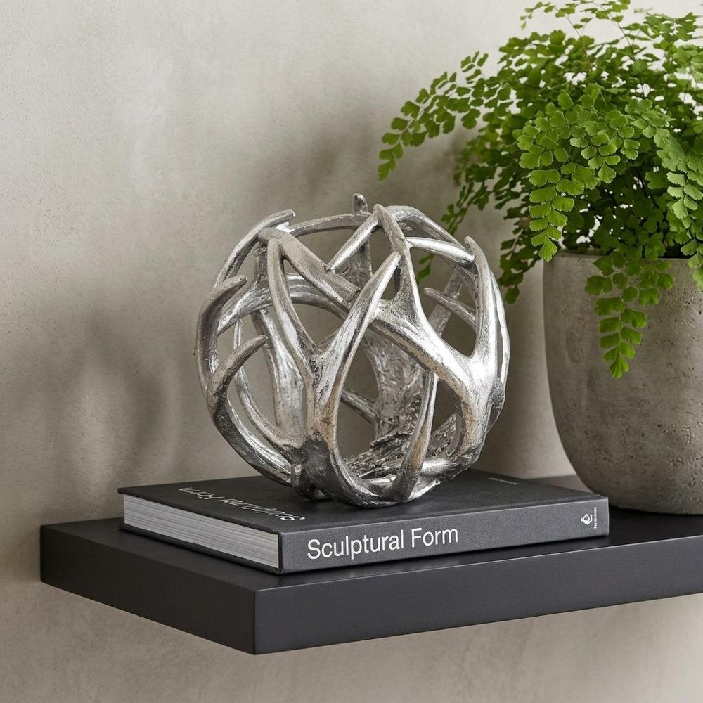 7" Silver Metal Tabletop Sculpture in a home interior