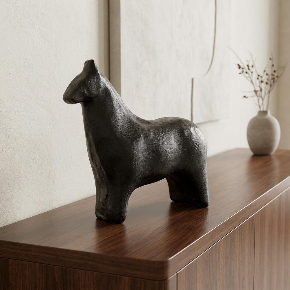 6" Gold Metal Horse Tabletop Sculpture displayed on a dark wood tabletop in a furnished interior against an off-white wall.