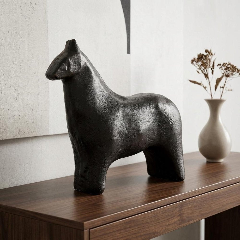6" Gold Metal Horse Tabletop Sculpture displayed on a dark wood tabletop in a furnished interior against an off-white wall.