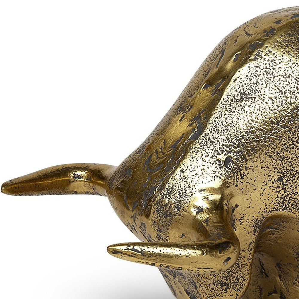 Gold Cast Aluminum Raging Bull Sculpture on a white background