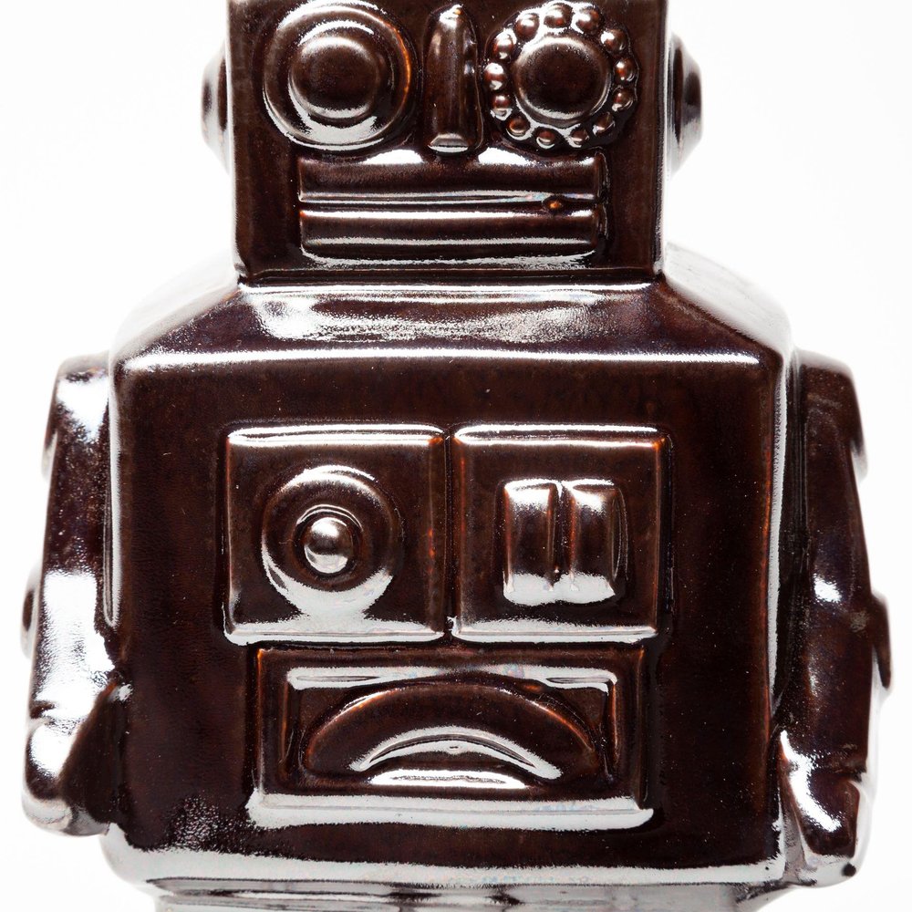 7" Silver Metal Robot Shaped Sculpture on a white background