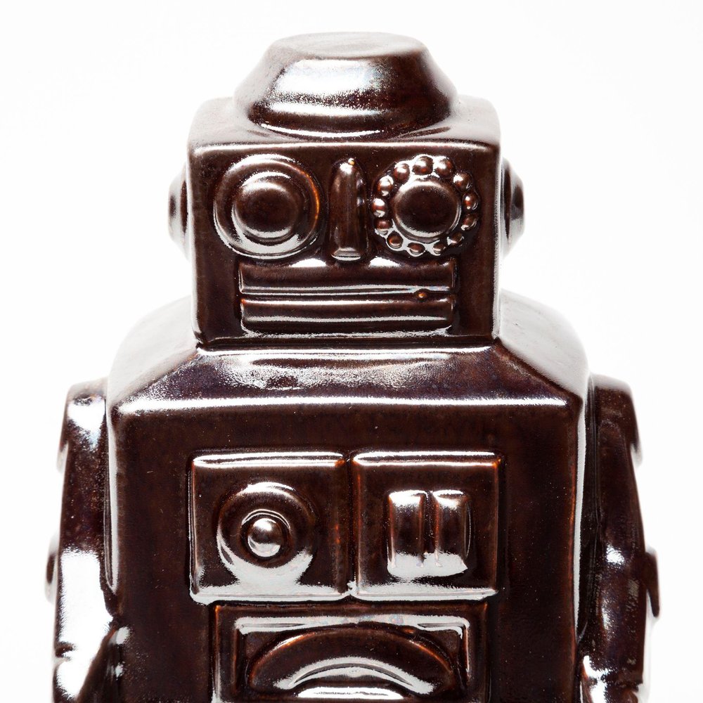 7" Silver Metal Robot Shaped Sculpture on a white background