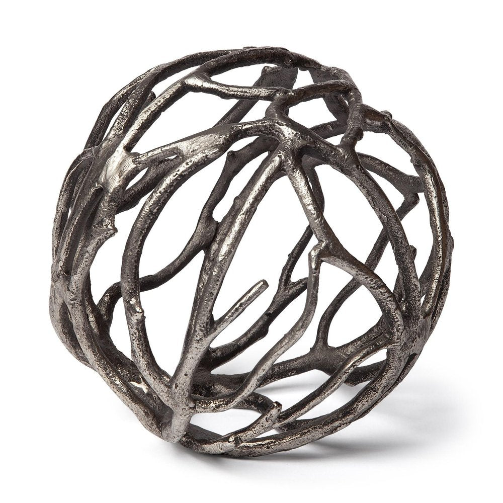 Silver metal sculpture of a sphere made of intertwined tree branches on a white background.