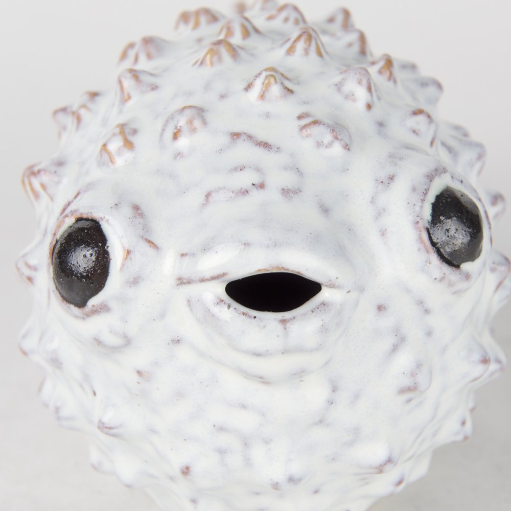 6" White Ceramic Puffer Fish Tabletop Sculpture. Sculpture isolated on a plain white background, in a off-white ceramic finish.