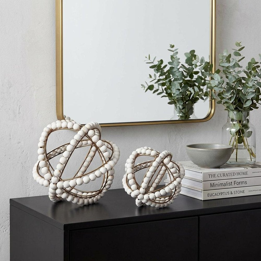 12" White Tabletop Sculpture styled in a furnished interior with an off-white wall on a black floor.