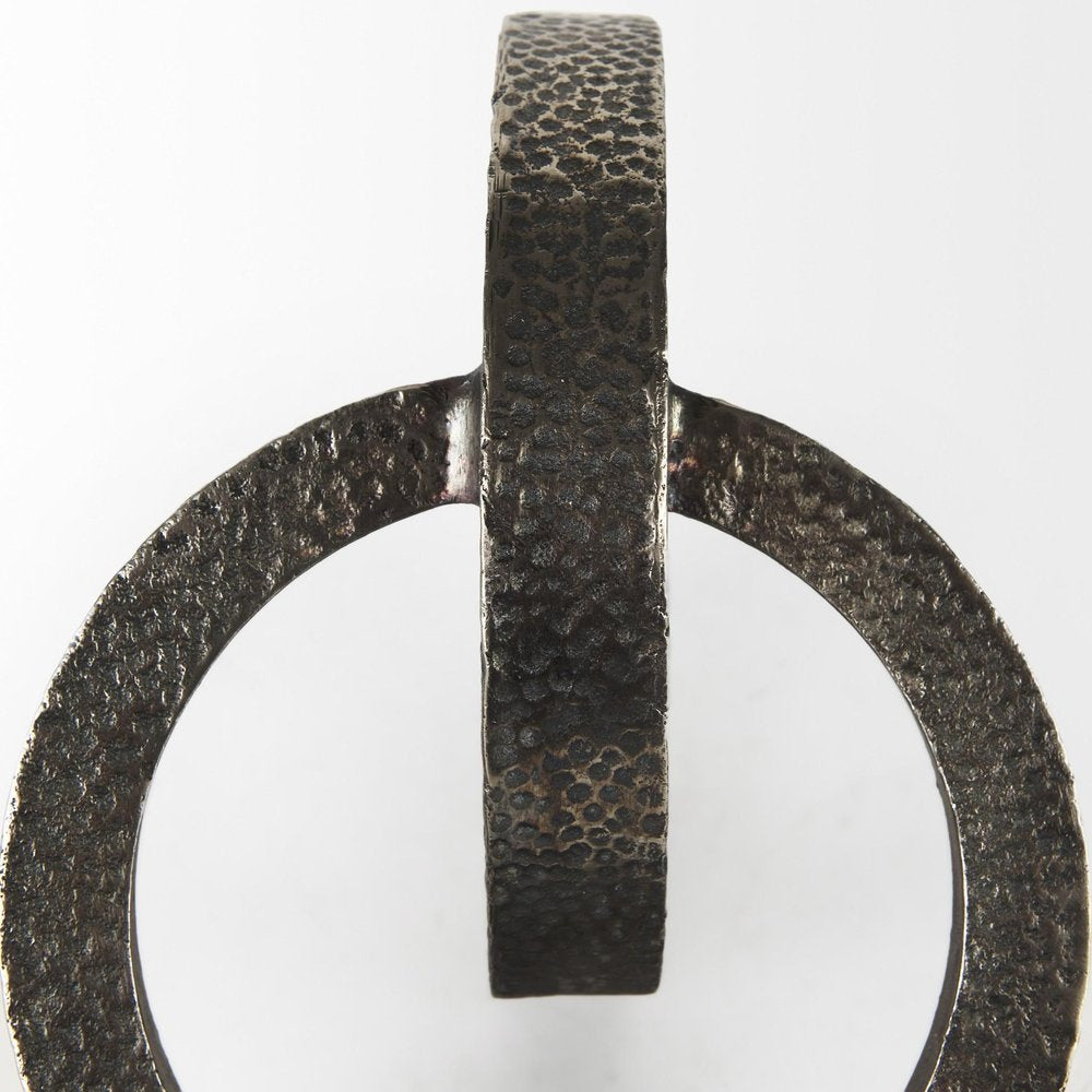 Two Ring Gray Hammered Metal Sculpture on a white background