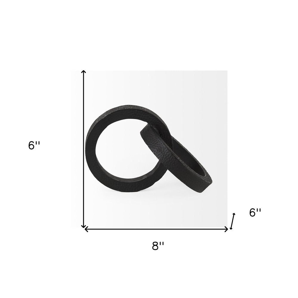 Two Ring Black Hammered Metal Sculpture on a white background