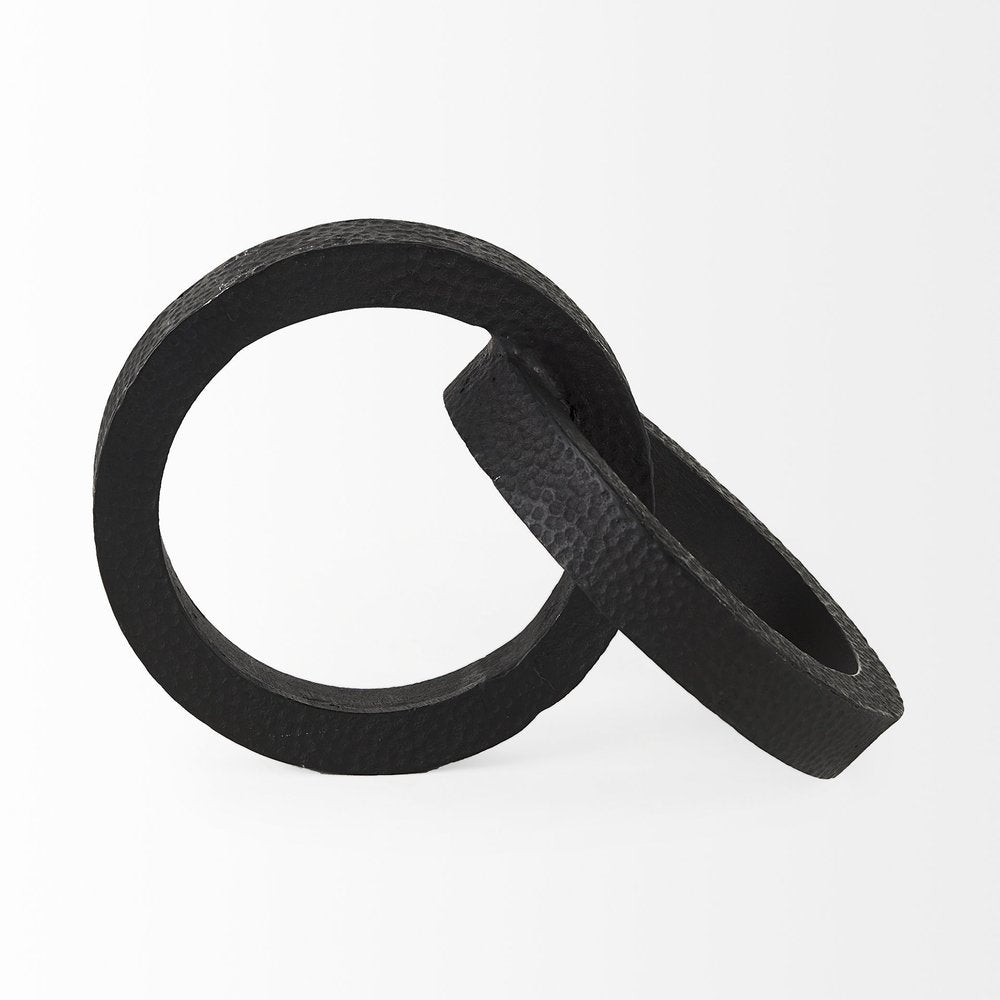 Two Ring Black Hammered Metal Sculpture on a white background
