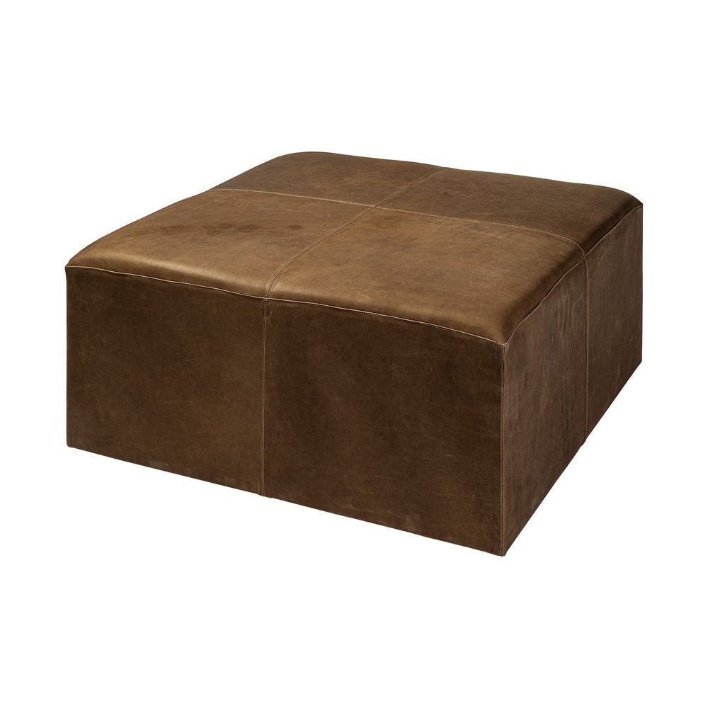 Brown genuine leather cube ottoman with stitched panel top and sides on a white background.