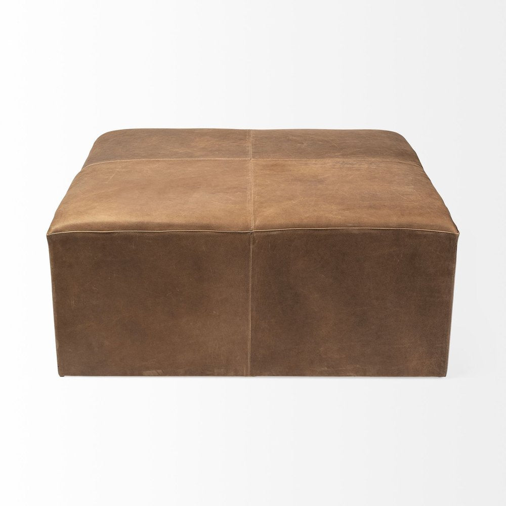 36" Brown Genuine Leather Cube Ottoman. Ottoman isolated on a plain white background, showing a brown leather surface.