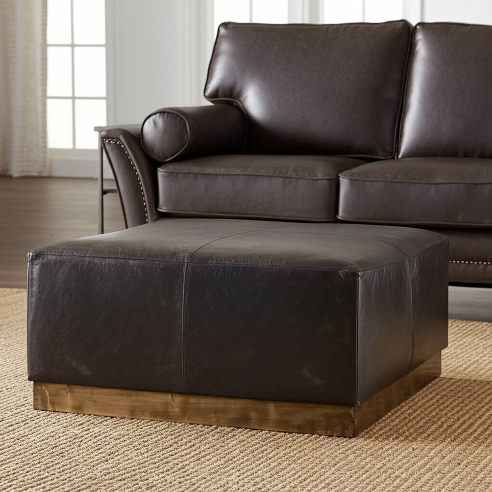 36" Black Faux Leather and Brown Footstool. Ottoman in black faux leather.