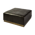Square black faux leather ottoman with a brass-finished base on a white background.