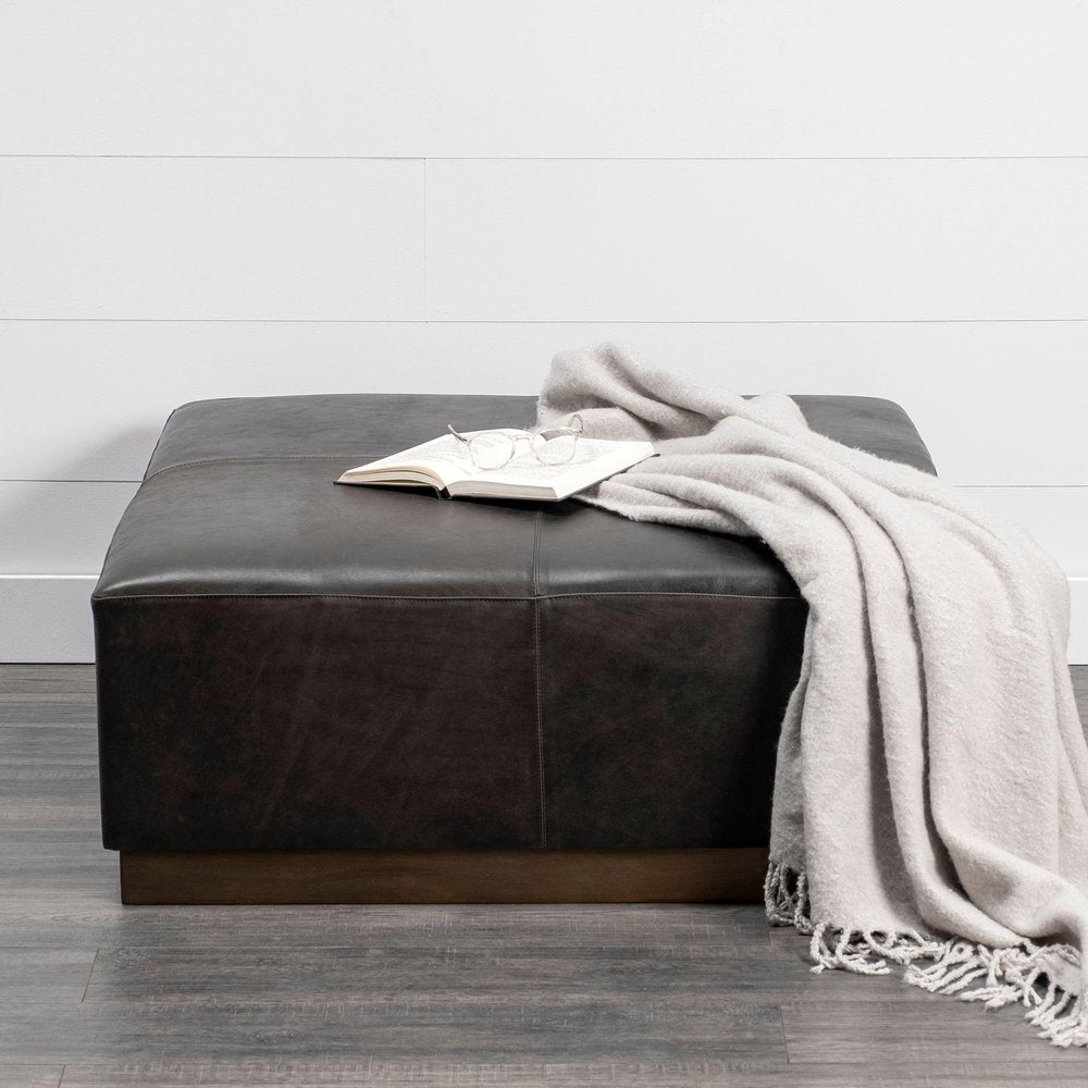 36" Black Faux Leather and Brown Footstool. Ottoman in black faux leather.