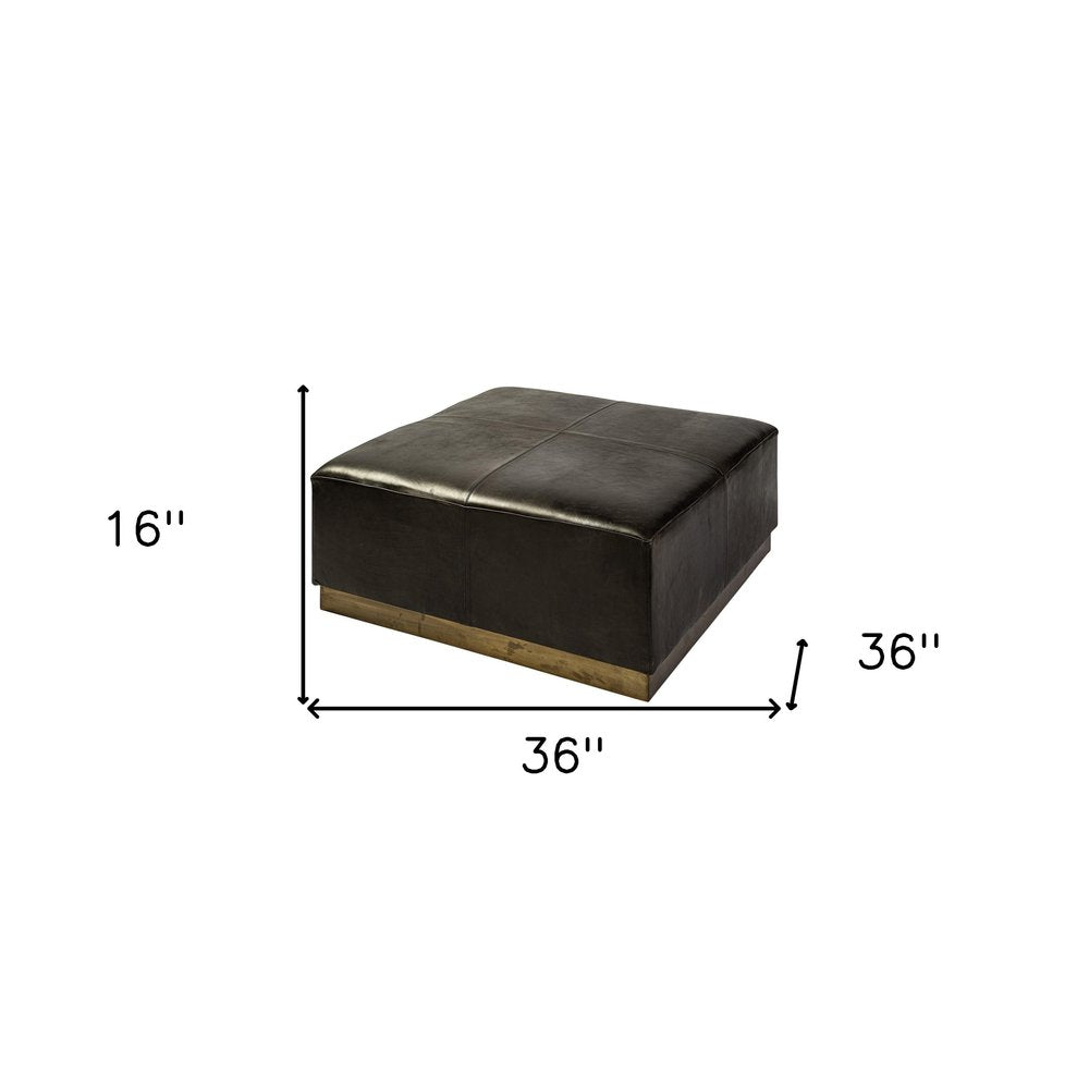 36" Black Faux Leather and Brown Footstool. Ottoman isolated on a plain white background, finished in black faux leather.