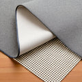 6' x 9' Ivory Striped Weave Non Slip Rug Pad shown as a full-frame view of the gray and tan surface.