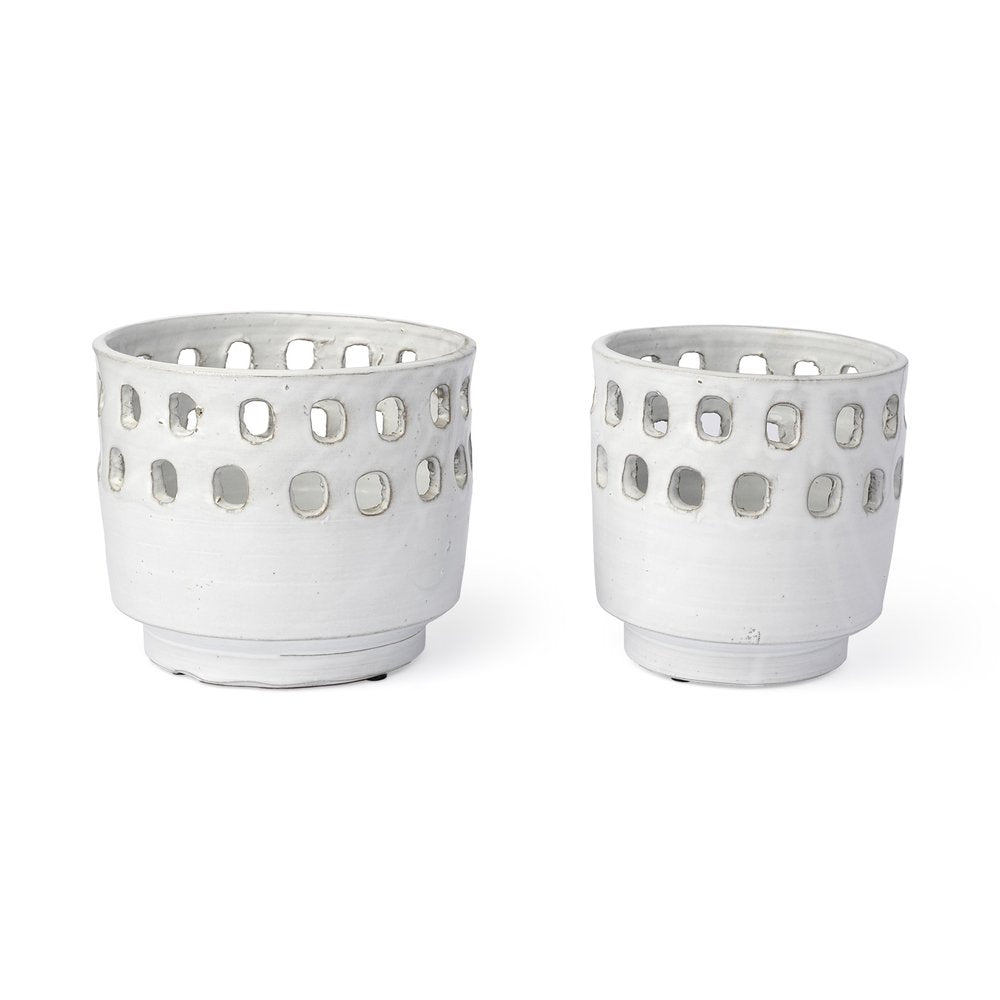 Two white ceramic cylinder vases with cut-out square patterns on a white background.