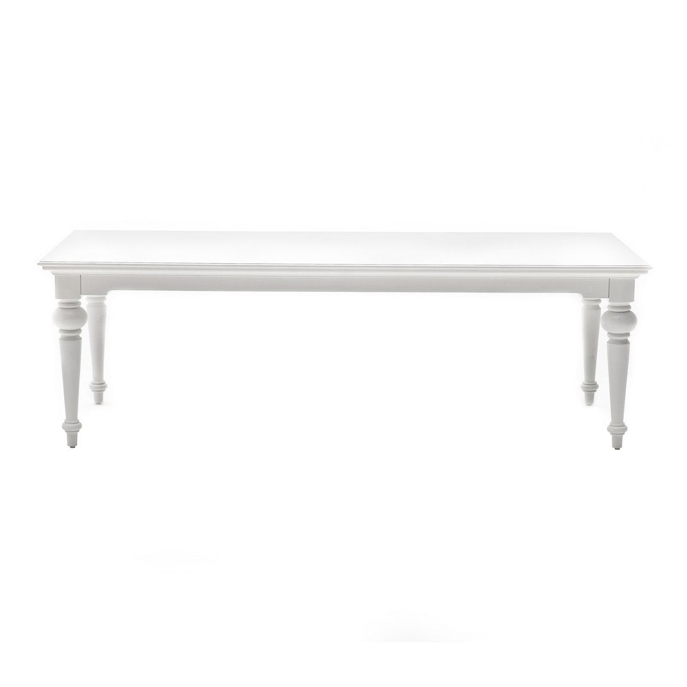 White solid wood dining table with turned legs on a white background.