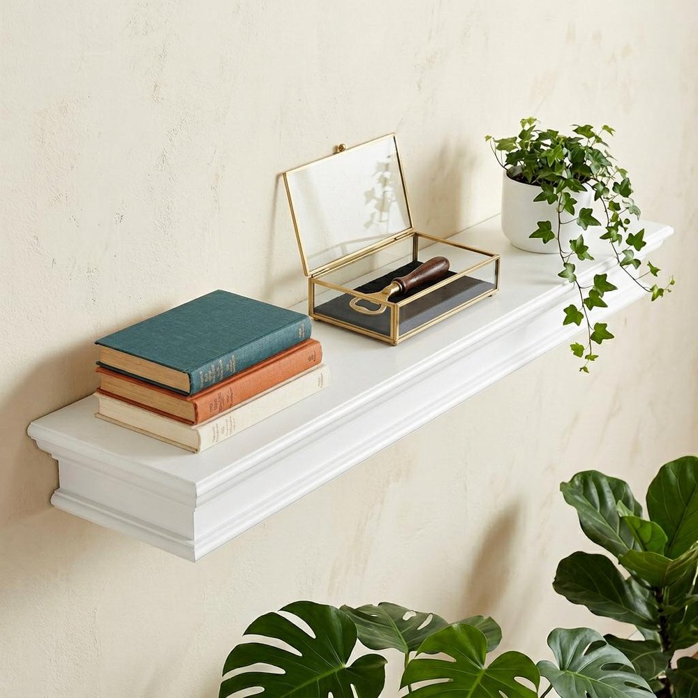 47" Classic White XL Floating Wall Shelf shown outdoors on a tiled patio with greenery.