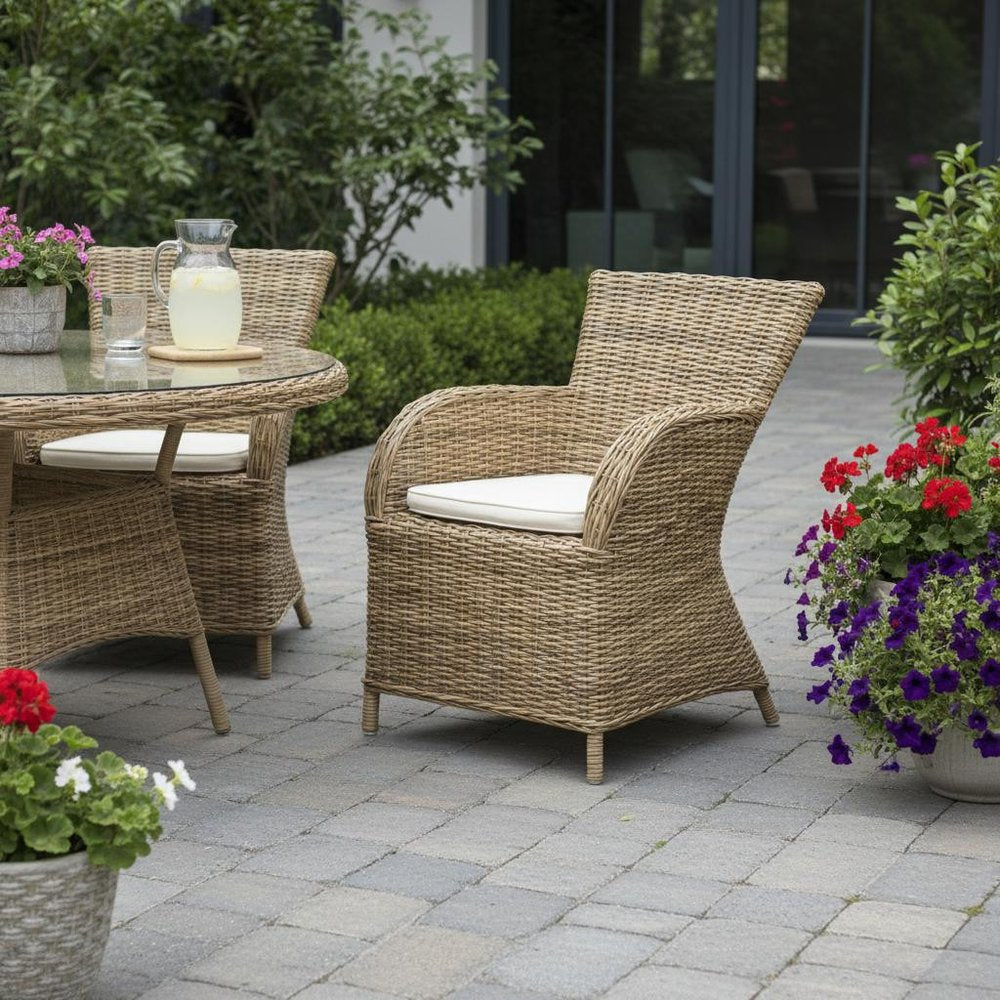 Set of Two Tan Textured Outdoor Dining Chairs with Beige Cushions in a home interior