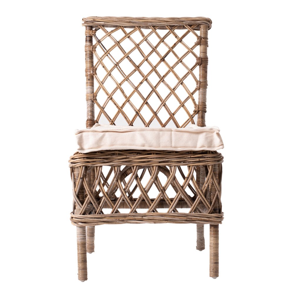Woven rattan accent chair with cream cushion on white background.