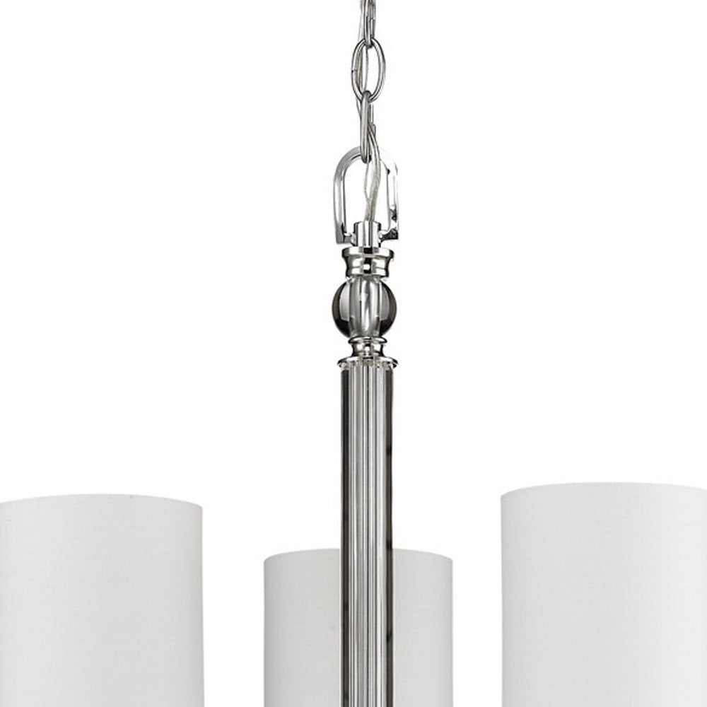 Silver Candle Style Three Light Metal and Crystals Dimmable Chandelier With White Shades on a white background