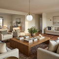 Brushed Gold Metal Hanging with Round Glass Shade in a home interior