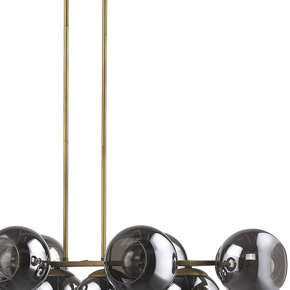 Lunette 10-Light Aged Brass Island Pendant on a white background